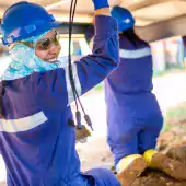 people - smiling worker in hard hat with others colombia