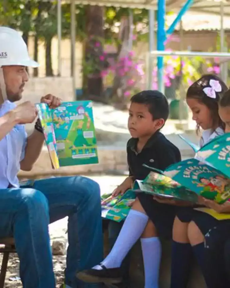 Energy worker reading storybook to children.